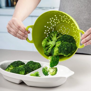 Tipping drained broccoli from Zeal Melamine Colander