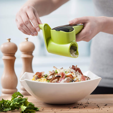 Cheese being grated over pasta carbonara