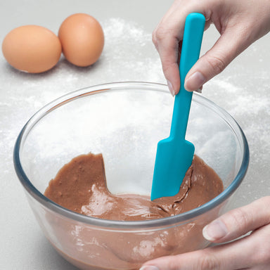 Using a Zeal Silicone Mini Baking Spatula to scrape a bowl