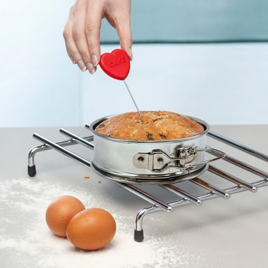 Testing a freshly baked cake with Perfect Bake Silicone Heart Cake Tester
